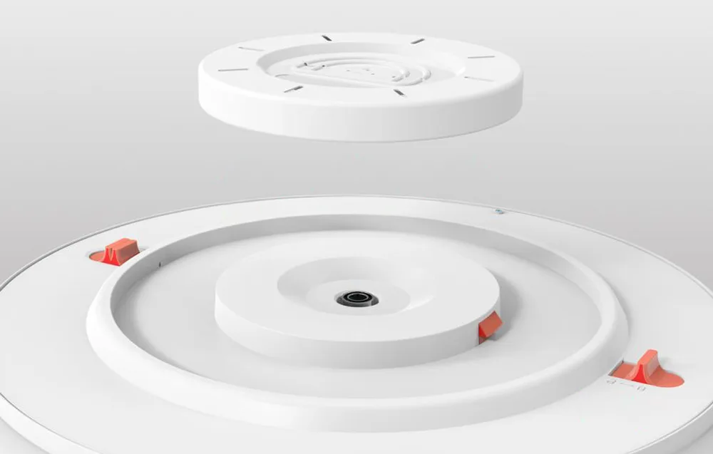 Valge ümmarguse laelambi kinnitusdetailide lähivõte, kinnituskohad esile tõstetud.